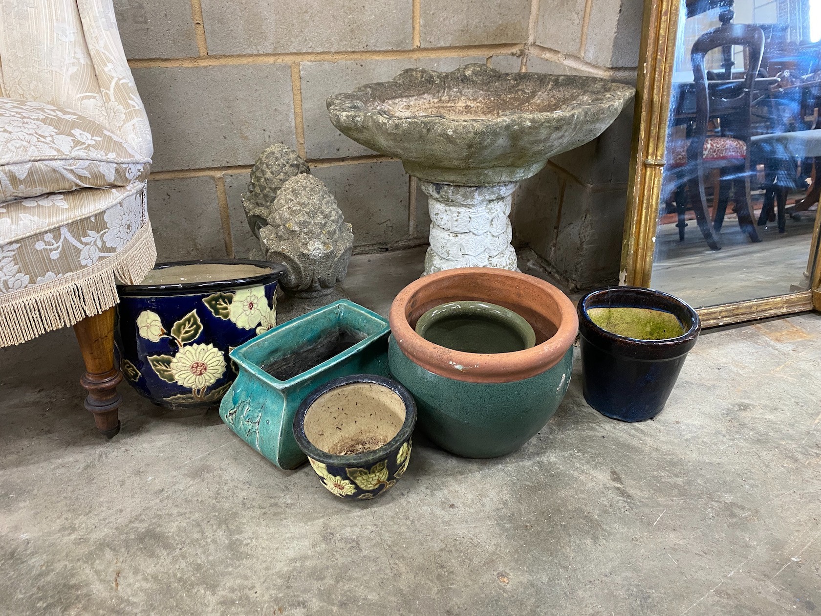 A reconstituted stone scallop shell bird bath, height 46cm, a pair of pineapple finials and six planters
